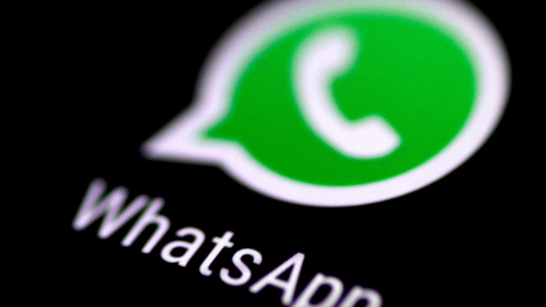 File photo: The WhatsApp messaging application is seen on a phone screen August 3, 2017. (REUTERS/Thomas White)