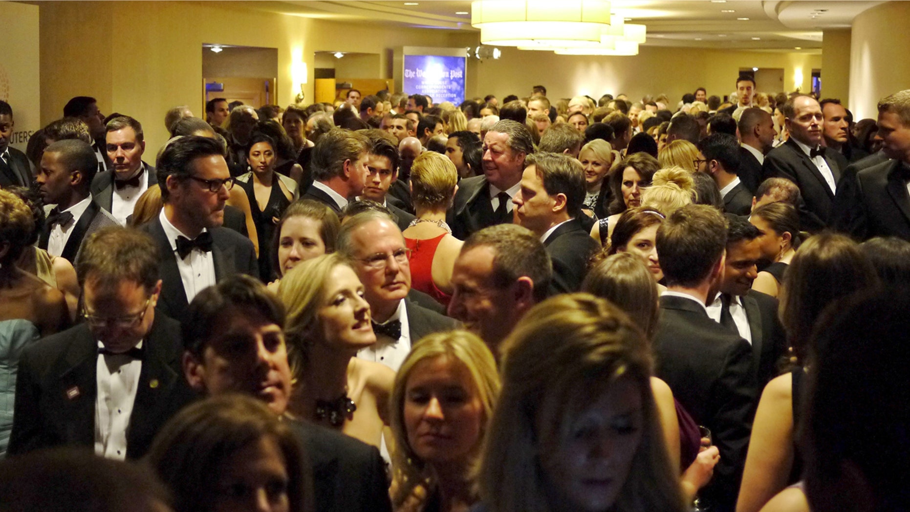 People crowd into the hallways as they leave their pre-parties to go to the ballroom for the White House Correspondents' Association dinner in Washington April 25, 2015.