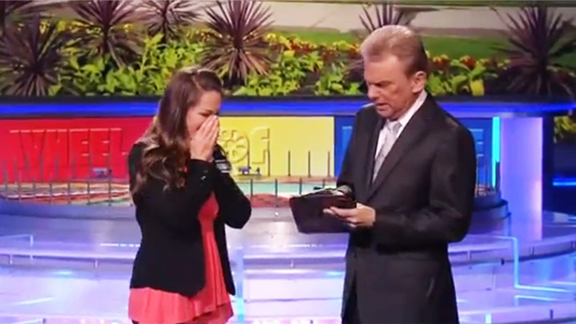 Autumn Ernhard stands beside Pat Sajack after winning $1 million on "Wheel of Fortune."