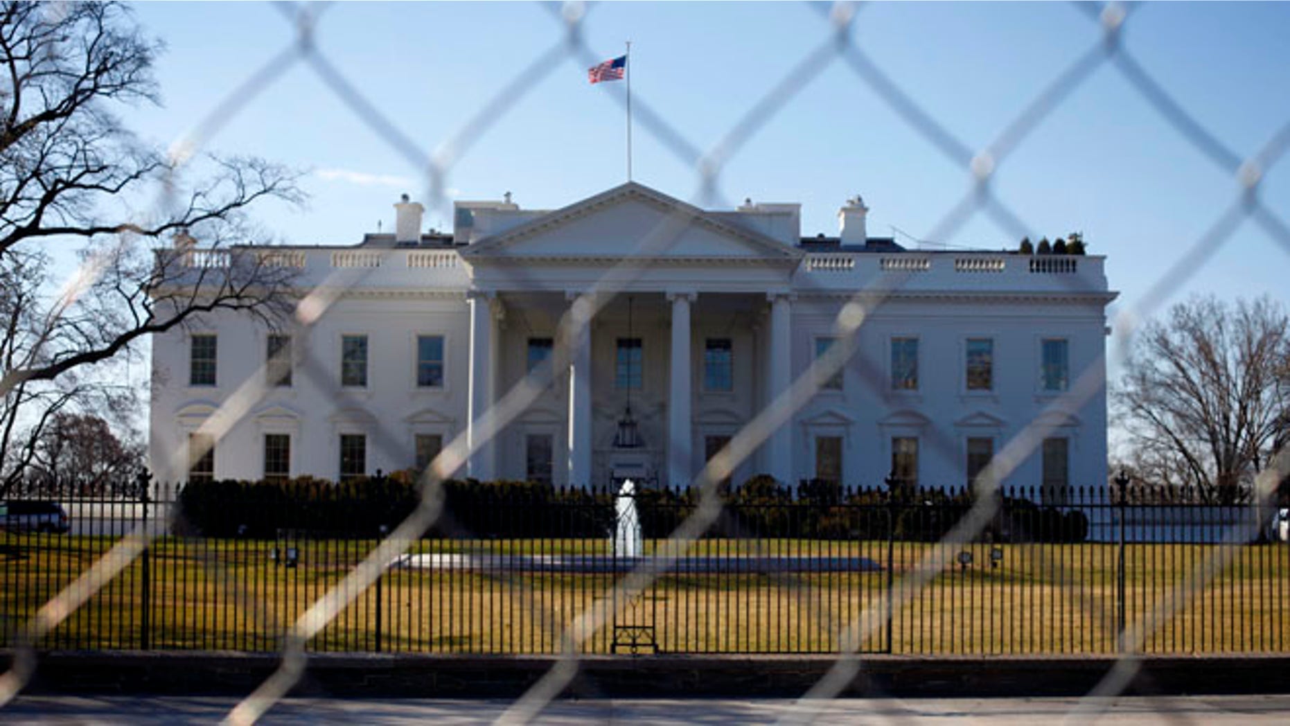 March 4, 2013: The White House is seen through a chain-link fence in Washington.