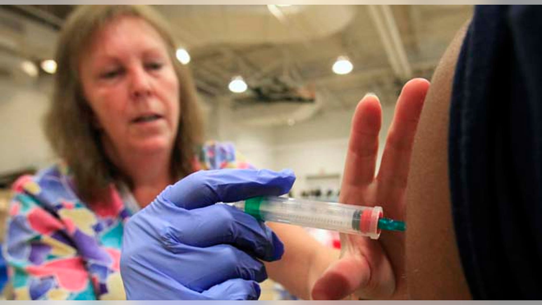Nurse Susan Peel gives a whooping cough vaccination to a student at Inderkum High School, Monday, Sept. 19, 2011, in Sacramento, Calif. The whooping cough vaccine given to babies and toddlers loses much of its effectiveness after just three years _ a lot faster than doctors believed _ and that could help explain a recent series of outbreaks in the U.S. among children who were fully vaccinated, a study suggests. (AP Photo/Rich Pedroncelli)