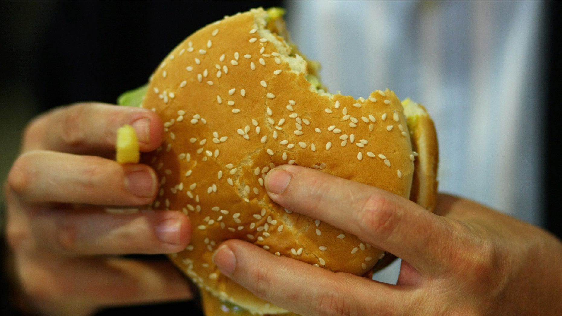 MUNICH, GERMANY - JUNE 15: A man eats a Whopper during the opening of the first European Whopper Bar on June 15, 2009 in Munich, Germany. Customers can choose from over 20 toppings for their Whopper burgers. (Photo by Miguel Villagran/Getty Images)