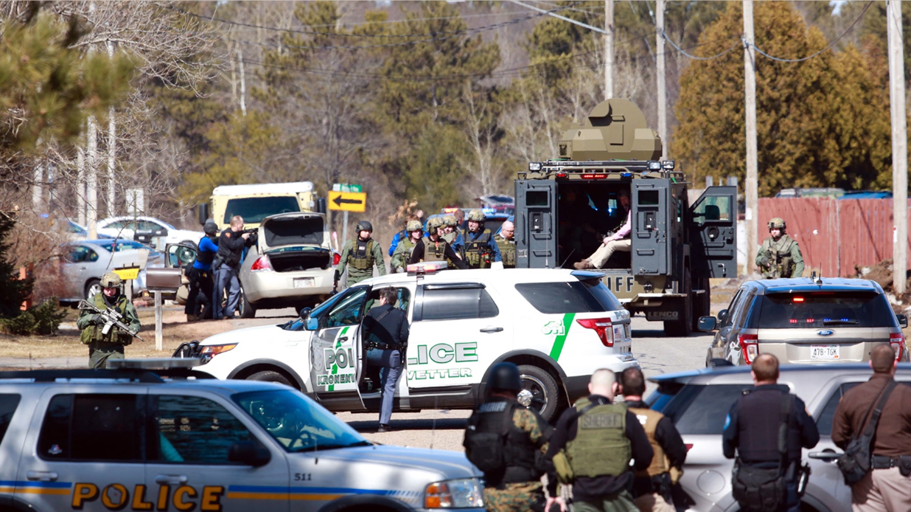 Numerous law enforcement vehicles and SWAT teams respond to shooter Wednesday, March 22, 2017, at an apartment complex in Rothschild, Wis.