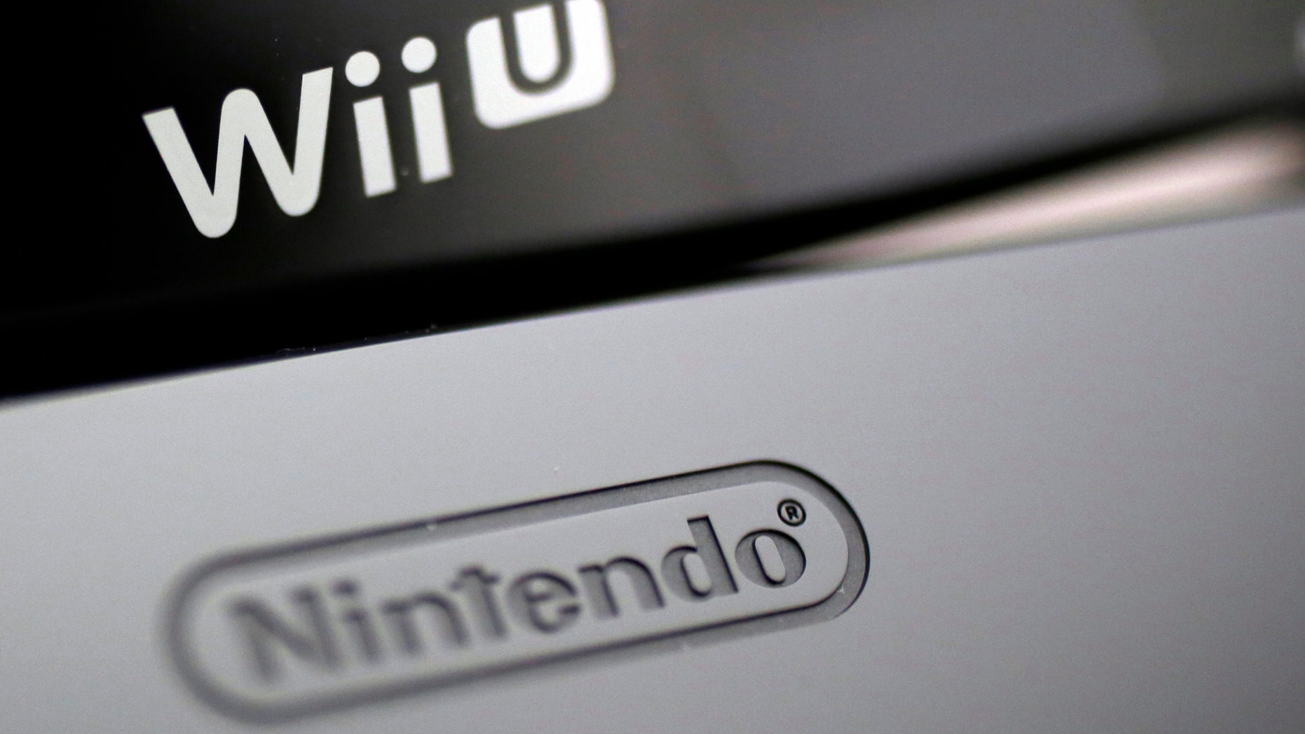 File photo - Logos are seen on Nintendo Co's Wii U game console (bottom) and its controller at the company headquarters in Kyoto, western Japan Jan. 7, 2013. (REUTERS/Yuriko Nakao)