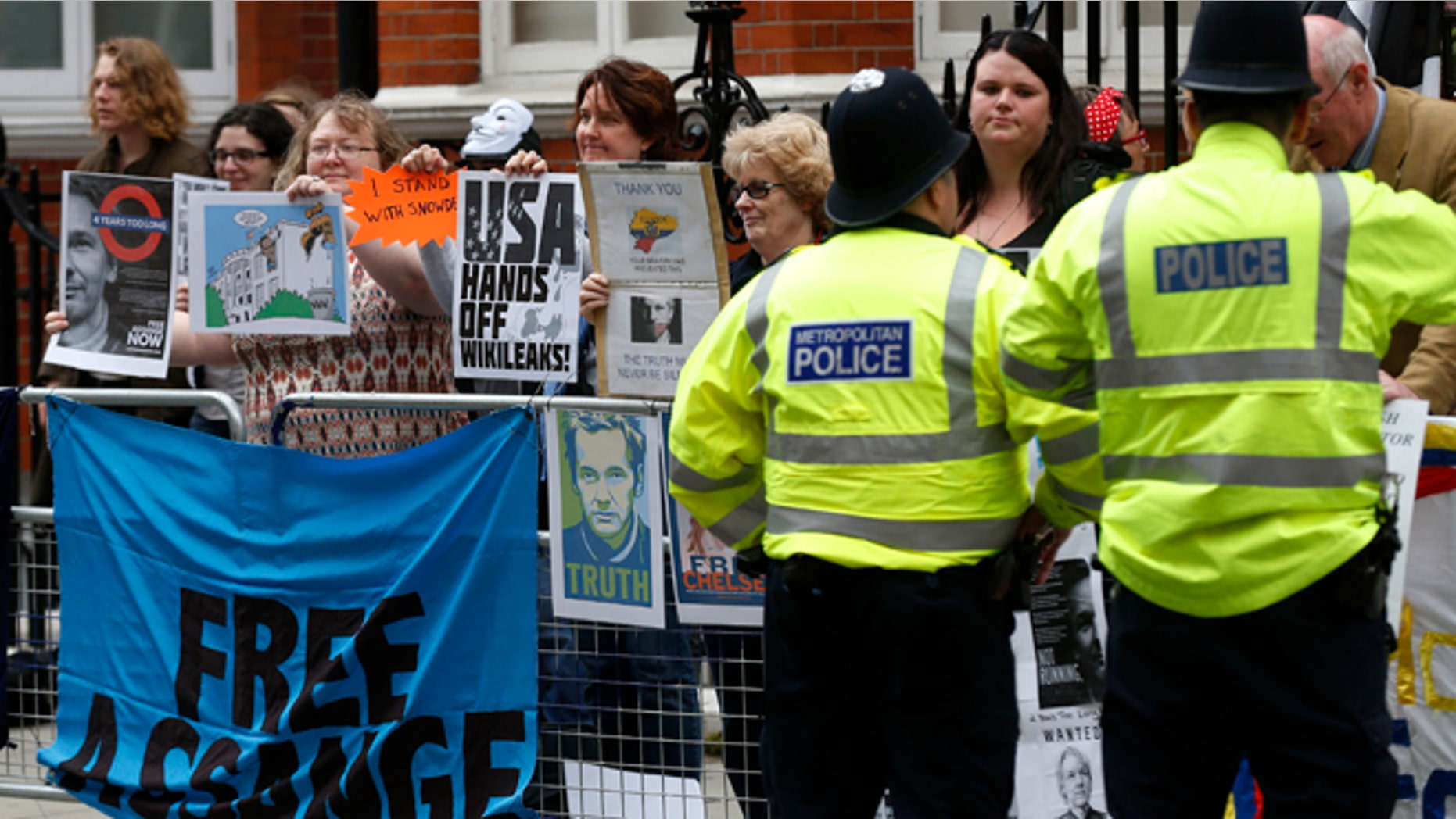June 19, 2014: Supporters of WikiLeaks founder Julian Assange hold a vigil outside the Ecuadorian Embassy in London to mark his two years in refuge at the embassy.