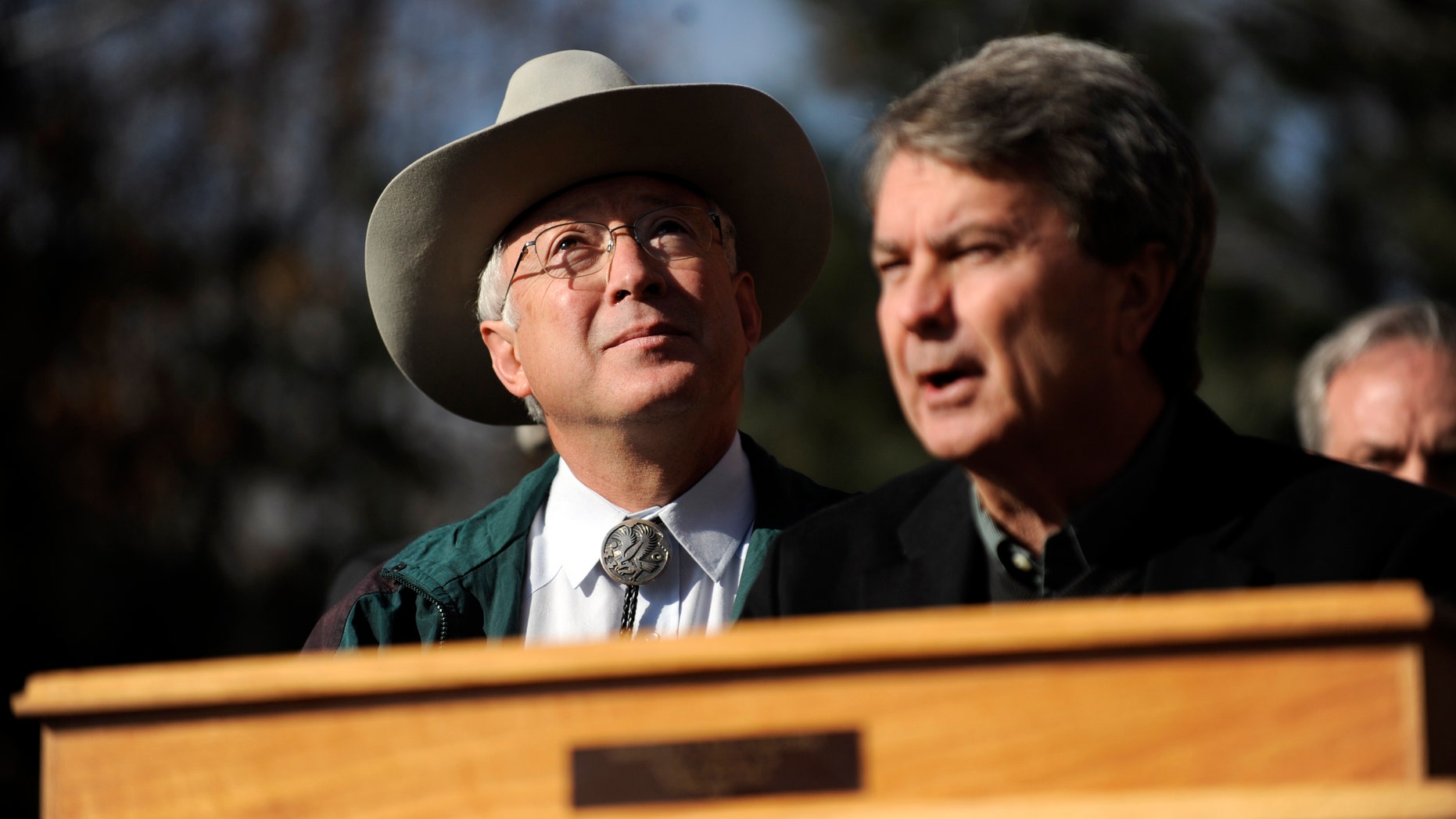 Secretary of the Interior Ken Salazar watches geese fly overhead as Bureau of Land Management Director Bob Abbey speaks about an initiative that would allow the BLM to designate and protect wilderness areas on Thursday, Dec. 23, 2010 outside of REI in Denver. (AP)