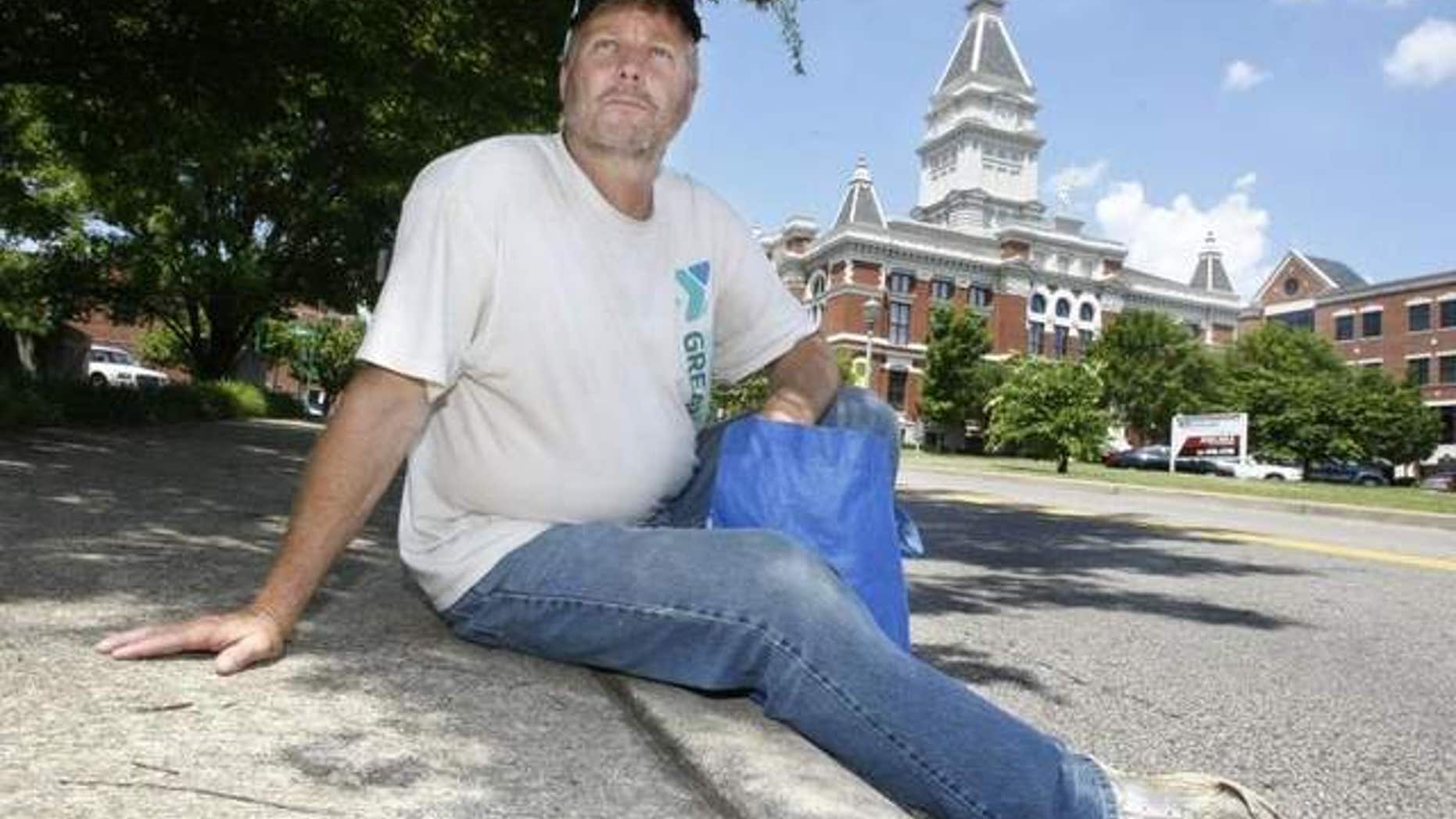 Rev. Willie Lyle rests along a curb in downtown Clarksville. The Sango United Methodist Chirch pastor went undercover living on the streets for a week. / THE LEAF-CHRONICLE/GREG WILLIAMSON