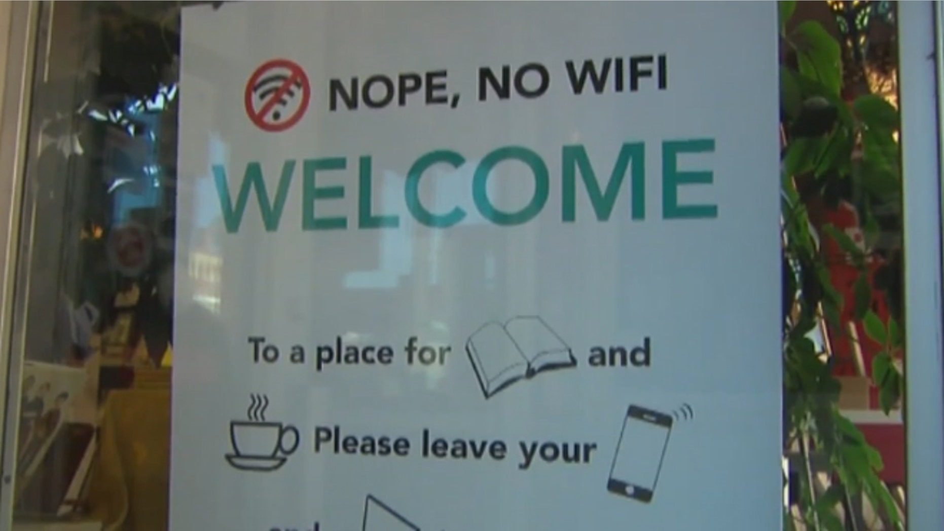 Sign at Wind City Books bans cellphones, laptops. (KTWO-TV)