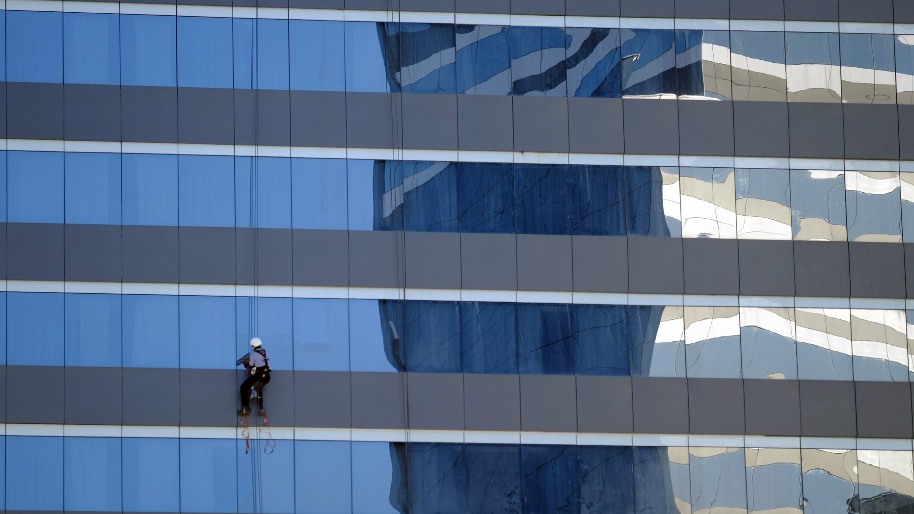 A window washer works outside a Marriott hotel near the Olympic Park before the start of the Rio 2016 Olympics in Rio de Janeiro, August 1, 2016. Picture taken August 1, 2016.