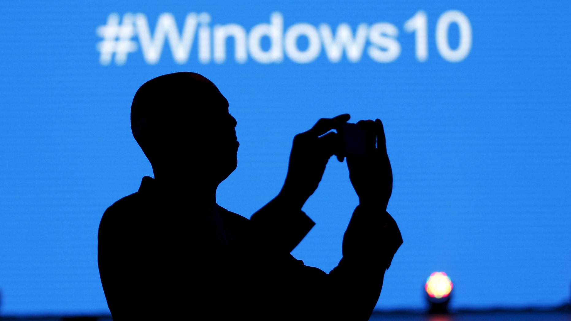 File photo - A Microsoft delegate takes a picture during the launch of the Windows 10 operating system in Kenya's capital Nairobi, July 29, 2015. (REUTERS/Thomas Mukoya)