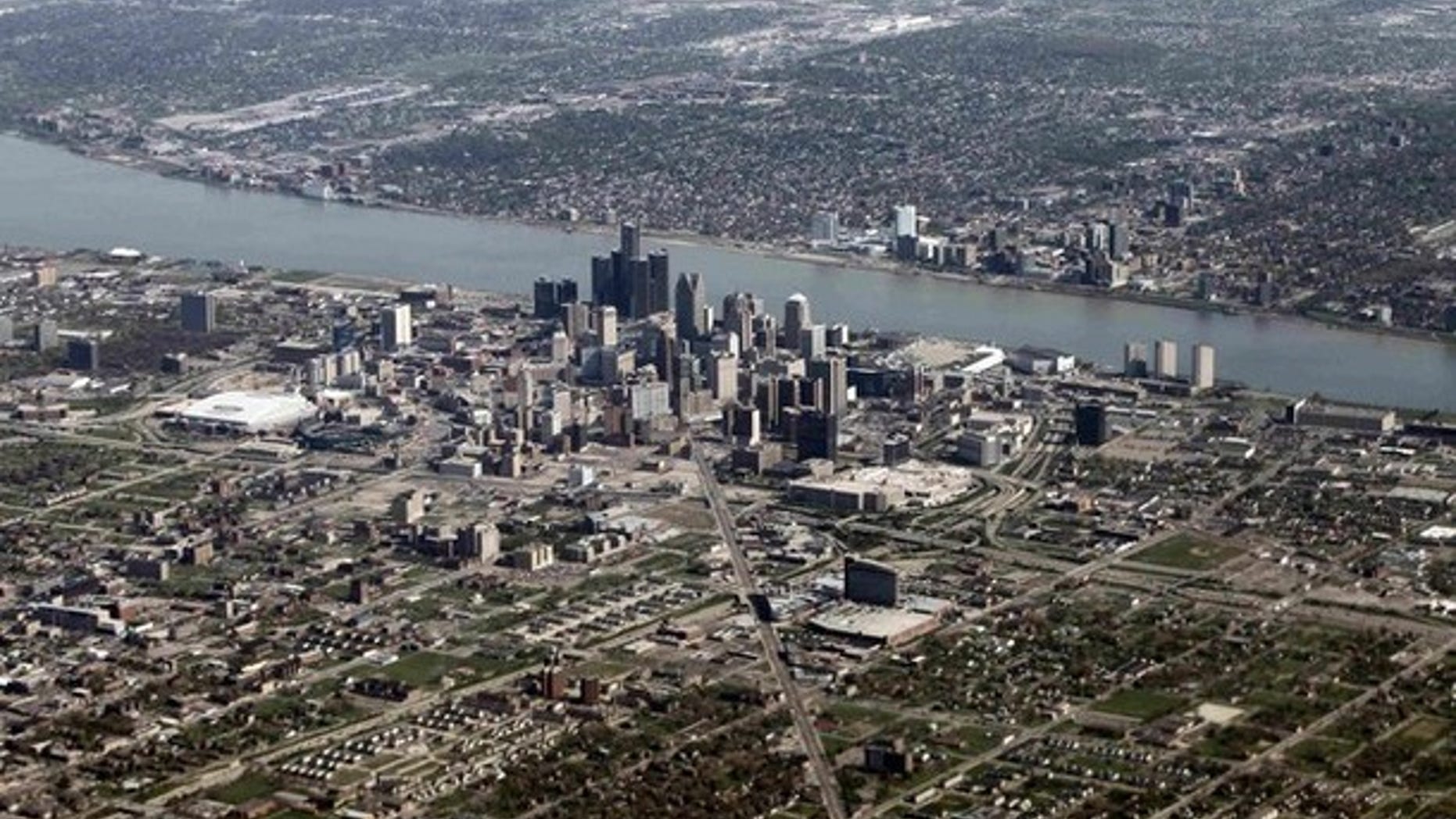 An aerial view of Detroit, Mich., seen in the foreground, while Windsor, Ontario lies on the opposite side of the Detroit River.