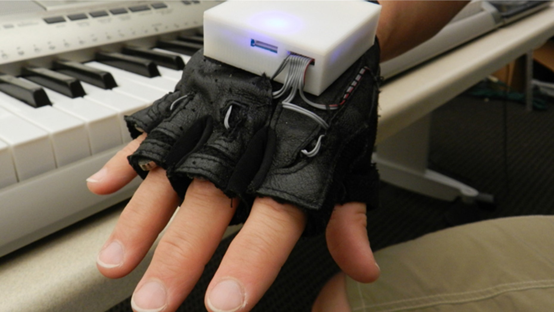 The glove, which looks like a workout glove with a small box on the back, is used with a piano keyboard and vibrates a persons fingers to indicate which keys to play. While learning to play the instrument, several people with SCI experienced improved sensation in their fingers.