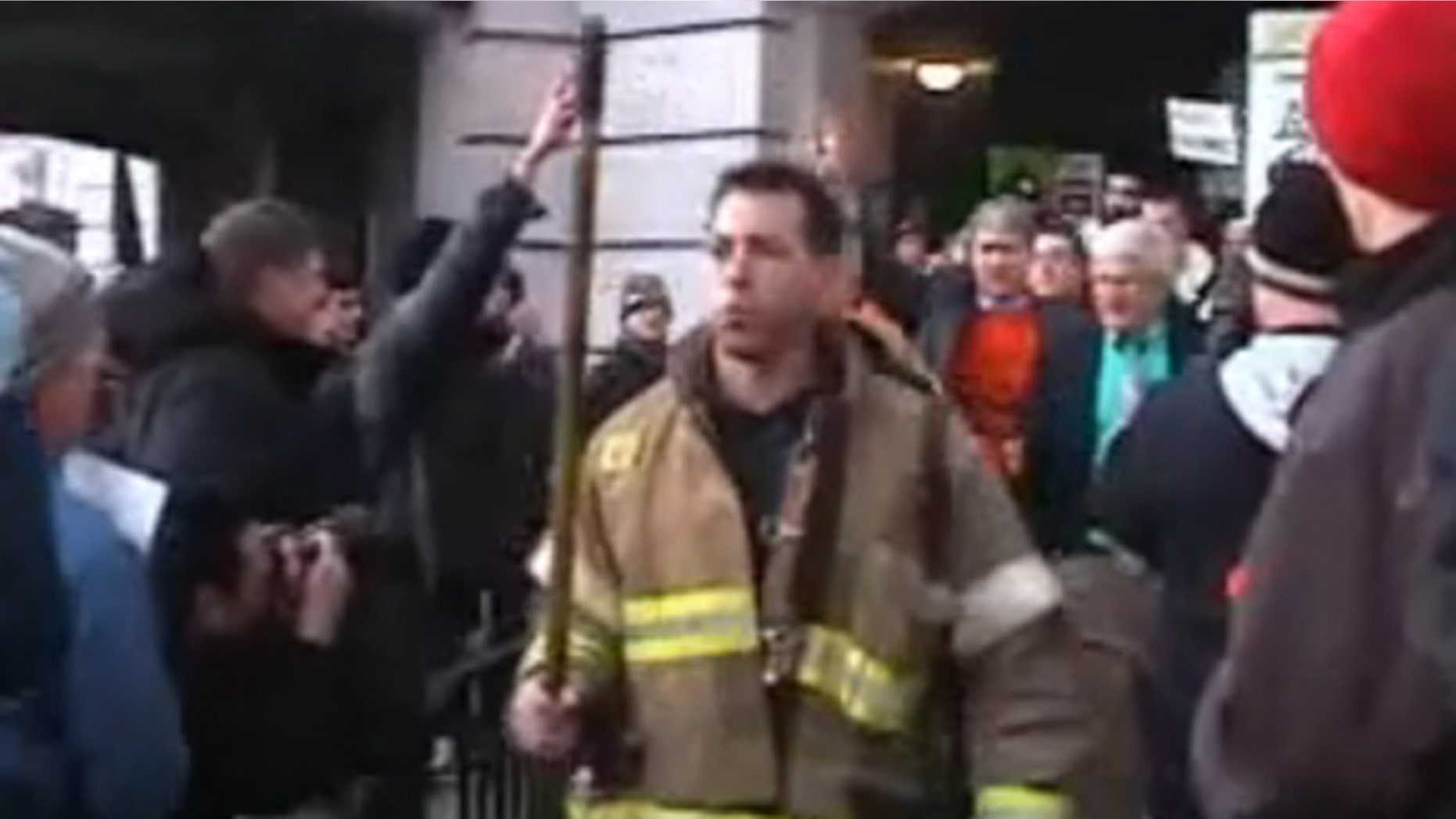 March 1, 2011: Protesters clear a path for firefighters to escort Sen. Glenn Grothman to an underground entrance to the Capitol.