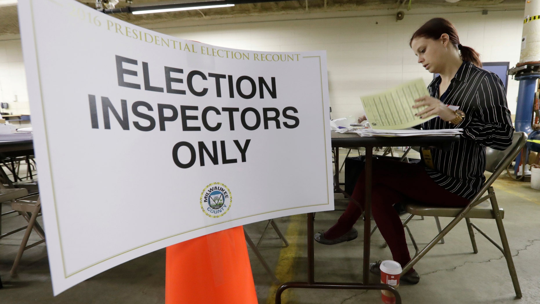 Nicole Kirby looks over results during a statewide presidential recount in Wisconsin