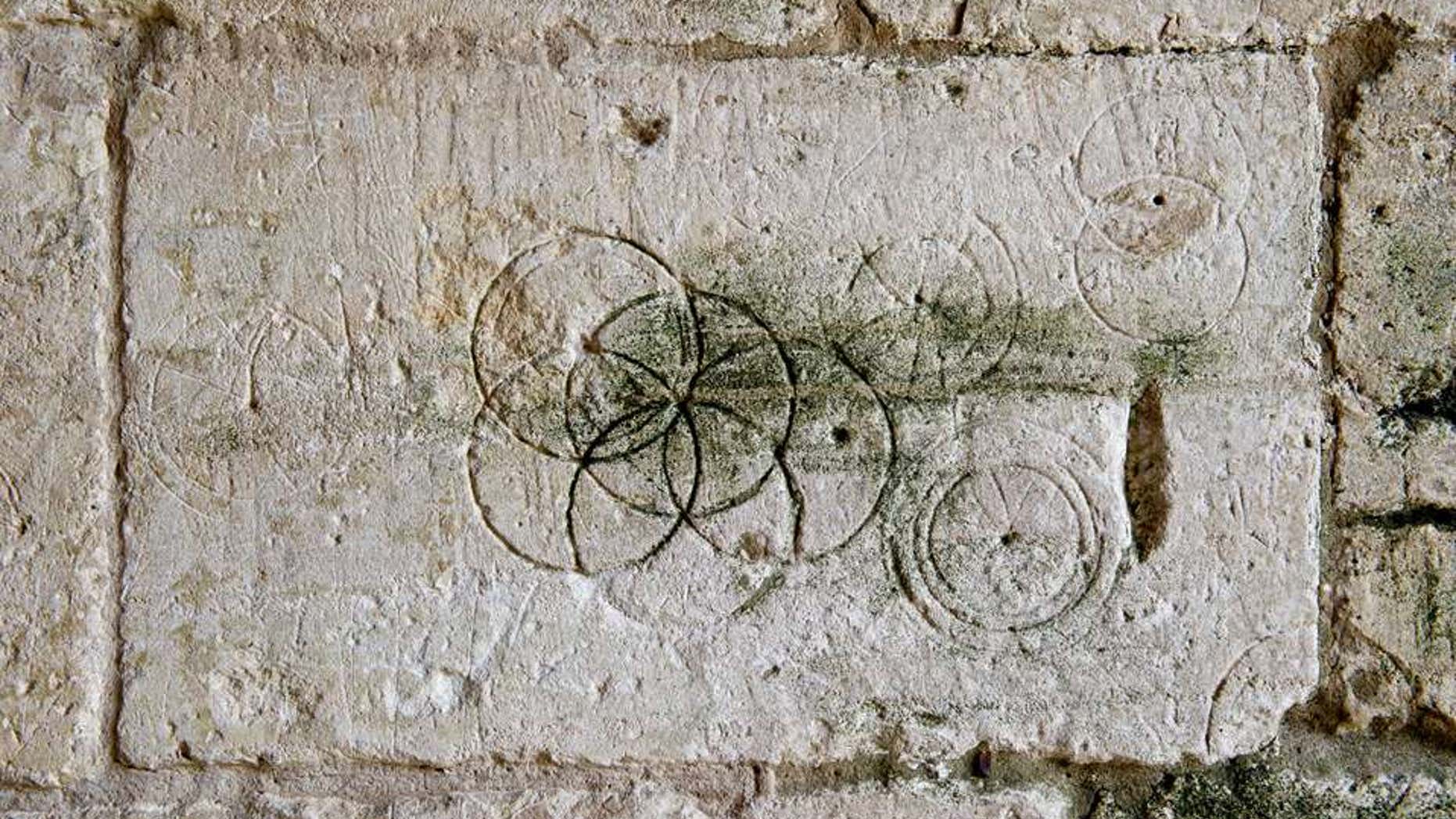 Daisy-Wheels inscribed with a pair of compasses or dividers found in Saxon Tithe barn, Bradford-on-Avon (Historic England).
