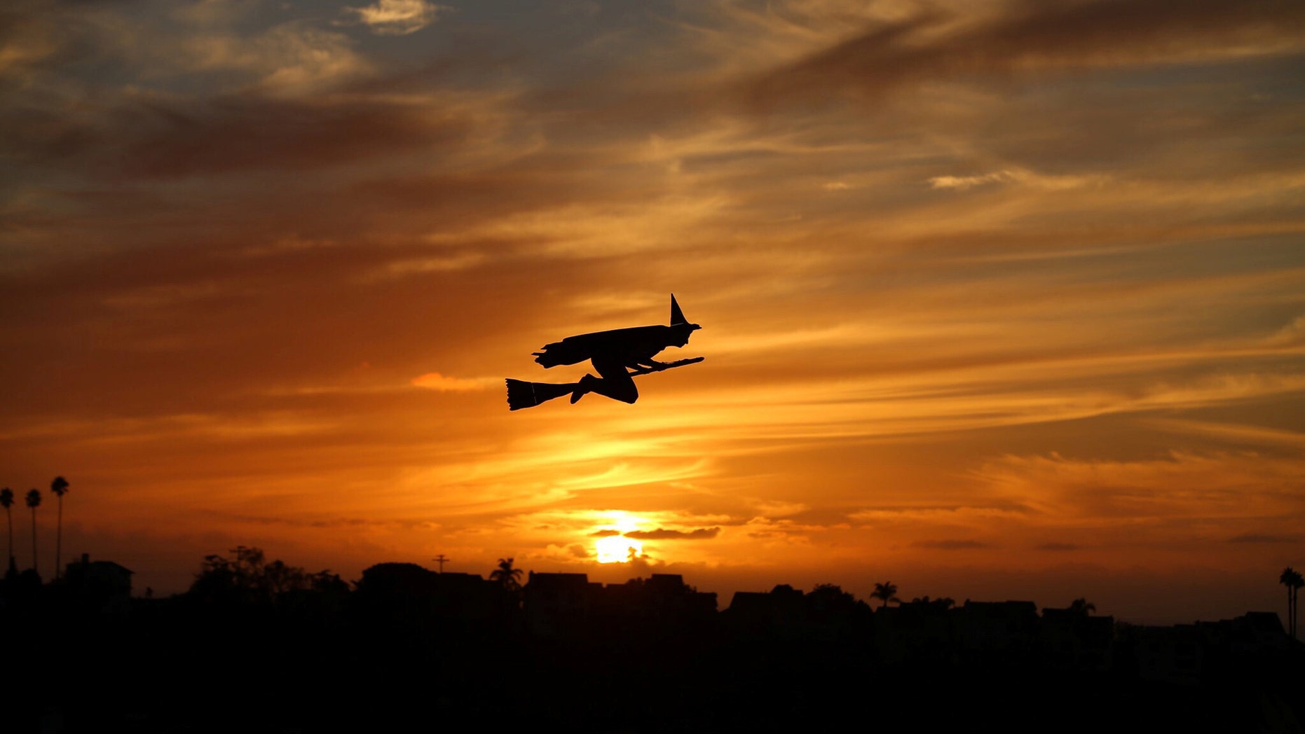 File photo - A remote-controlled plane in the form of a witch flies over a neighborhood as the sun sets during Halloween in Encinitas, California, U.S. Oct. 31,2016. (REUTERS/Mike Blake)
