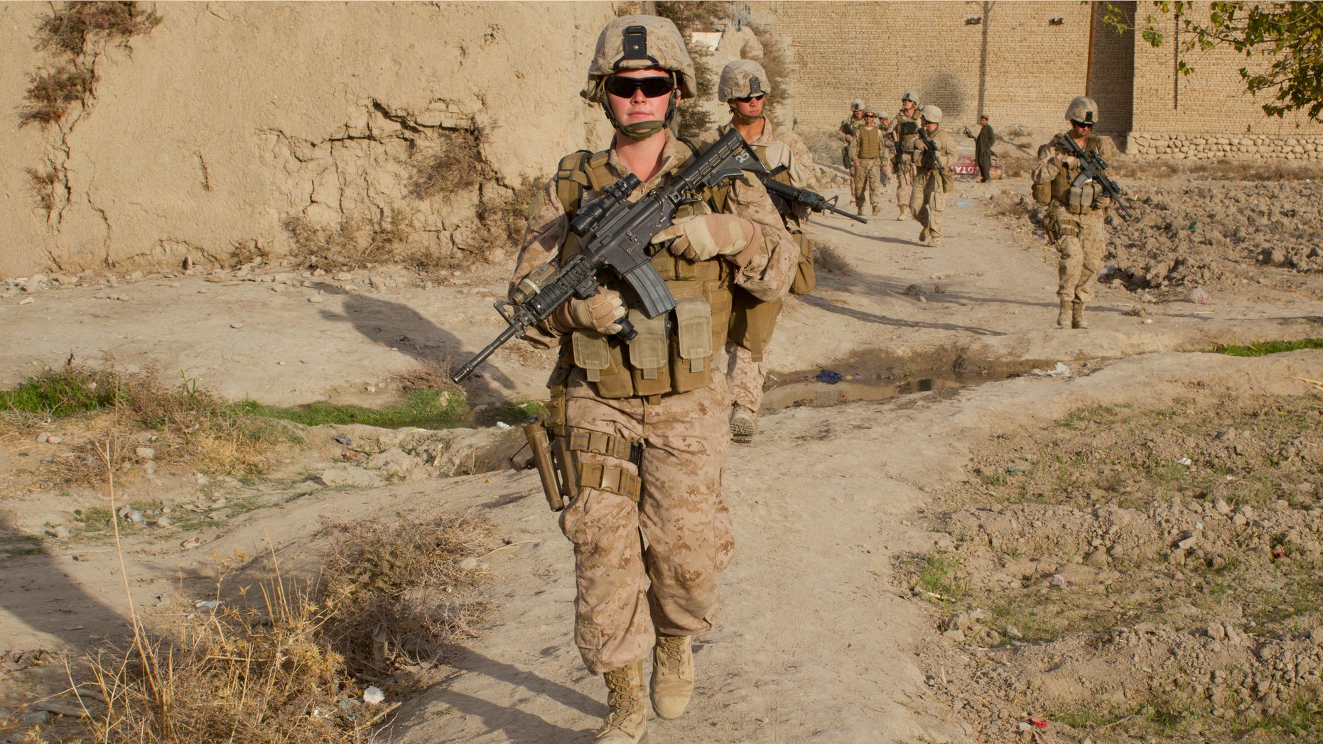 Lance Corporal Kristi Baker,21, US Marine with the FET (Female Engagement Team) 1st Battalion 8th Marines, Regimental Combat team II patrols with other Marines on November 20, 2010 in Musa Qala, Afghanistan.