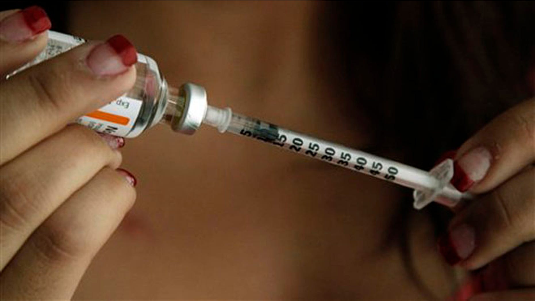 Judith Garcia, 19, fills a syringe as she prepares to give herself an injection of insulin at her home in the Los Angeles suburb of Commerce, Calif., Sunday, April 29, 2012. A major study, released Sunday, tested several ways to manage blood sugar in teens newly diagnosed with diabetes and found that nearly half of them failed within a few years and 1 in 5 suffered serious complications. Garcia still struggles to manage her diabetes with metformin and insulin years after taking part in the study at Children's Hospital Los Angeles. (AP Photo/Reed Saxon)