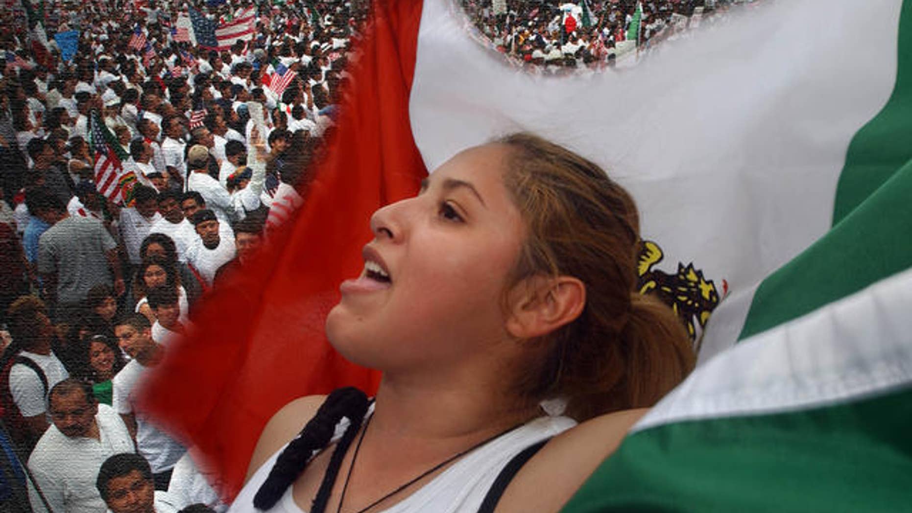 Anabel Chavarria, 17, waves a Mexican flag as she joins demonstrators gathered to protest federal immigration legislation in front of City Hall in Los Angeles, Saturday March 25, 2006. The U.S. House of Represenatives passed a bill that would make it a felony to be in the U.S. illegally, impose new penalties on employers who hire illegal immigrants and erect fences along one-third of the U.S.-Mexican border. The Senate is to begin debating the proposals on Tuesday. (AP Photo/Ann Johansson)