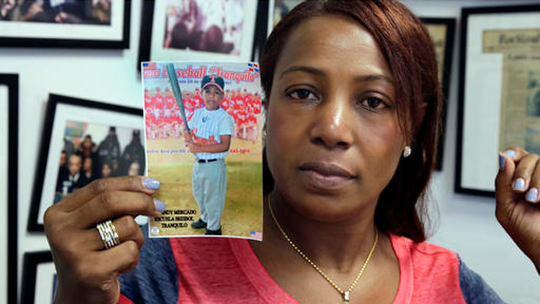 Maribel Martinez holds a photo of her son Andy at her attorney's office, in the Brooklyn borough of New York, Thursday, Sept. 1, 2016. Martinez says she hasn't stopped crying since JetBlue airlines mistook her 5-year-old for another child and flew him to the wrong city. (AP Photo/Richard Drew)