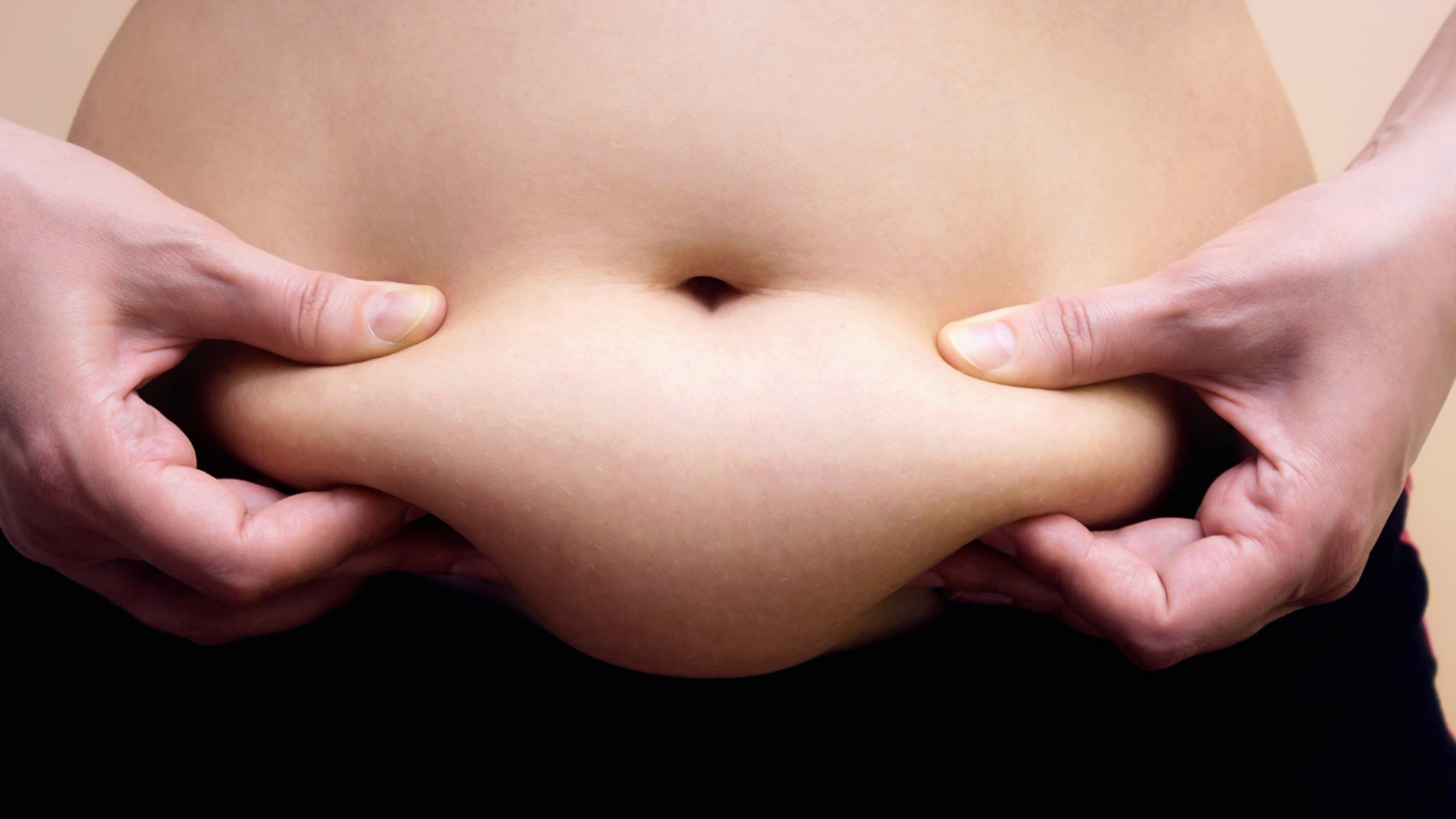 Obese women shows fat on her stomach, Photography