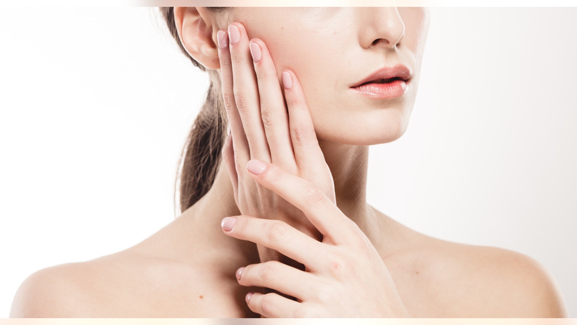 Woman shoulders lips hands fingers close-up portrait. Studio shot.