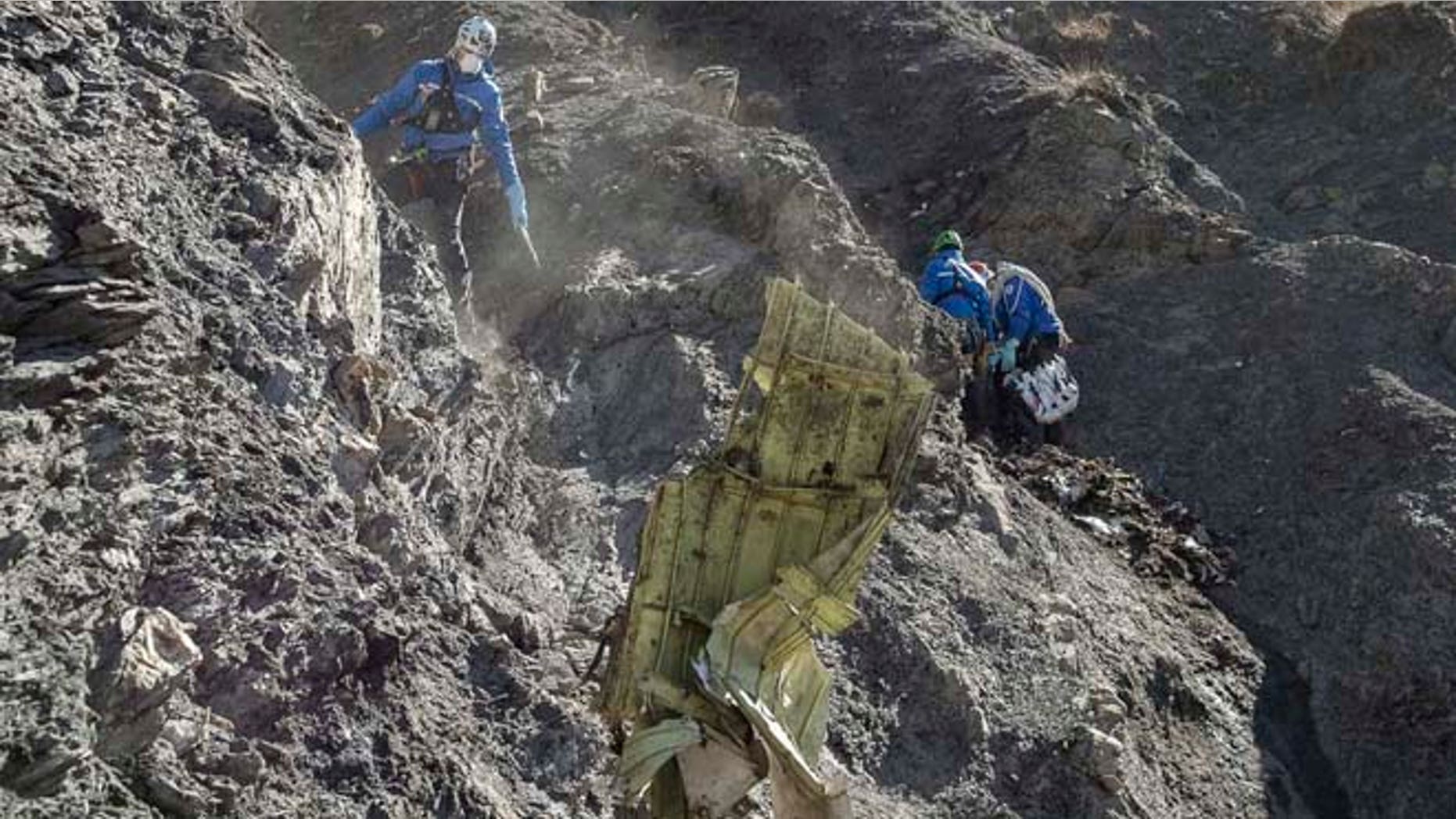 In this photo provided April 3, 2015 by the French Interior Ministry, French emergency rescue services work among debris of the Germanwings passenger jet at the crash site near Seyne-les-Alpes, France.