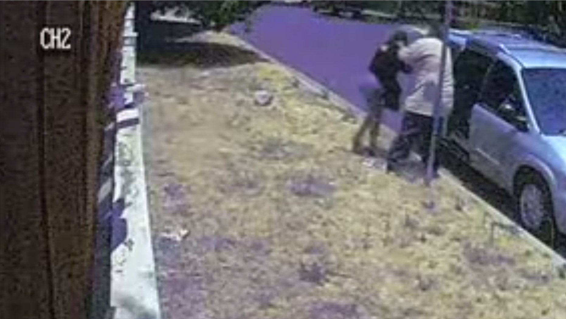Authorities are searching for a man who is suspected of kidnapping a woman by forcing her into a minivan in an incident that was caught on camera.