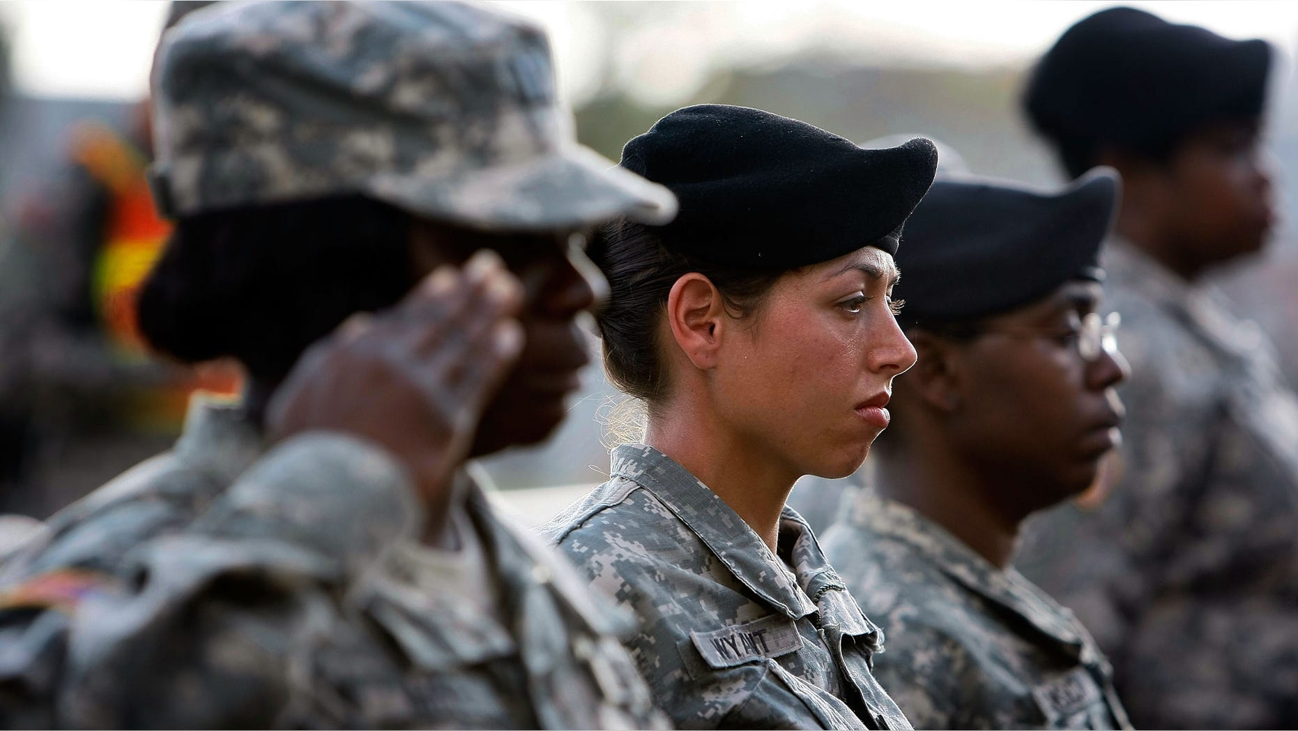 FORT HOOD, TX - NOVEMBER 10: U.S. Army soldiers stand together as they salute during the memorial service that U.S. President Barack Obama and first lady Michelle Obama attended in honor of the thirteen victims of the shooting rampage allegedly by U.S. Army Major Nidal Malik Hasan on November 10, 2009 in Fort Hood, Texas. Hasan, an army psychiatrist, is accused of killed 13 people and wounded 30 in a shooting at the military base on November 5, 2009. (Photo by Joe Raedle/Getty Images)