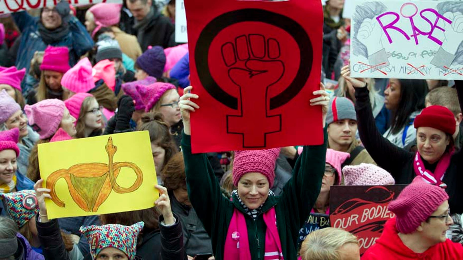 Jan. 21, 2017: Women with bright pink hats and signs gather early and are set to make their voices heard on the first full day of Donald Trump's presidency.
