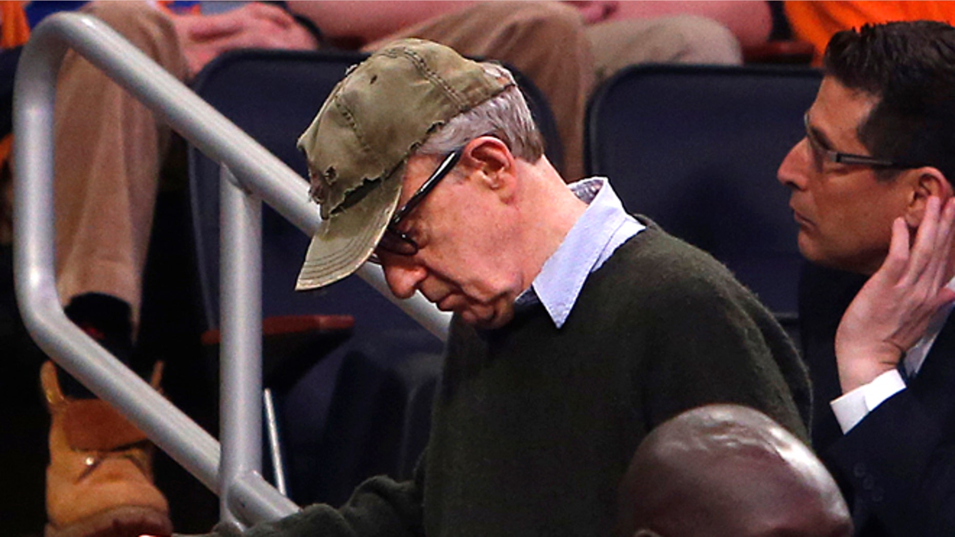 Feb. 1, 2014: Filmmaker Woody Allen, left, leaves late in the fourth quarter of an NBA basketball game between the Miami Heat and the New York Knicks.