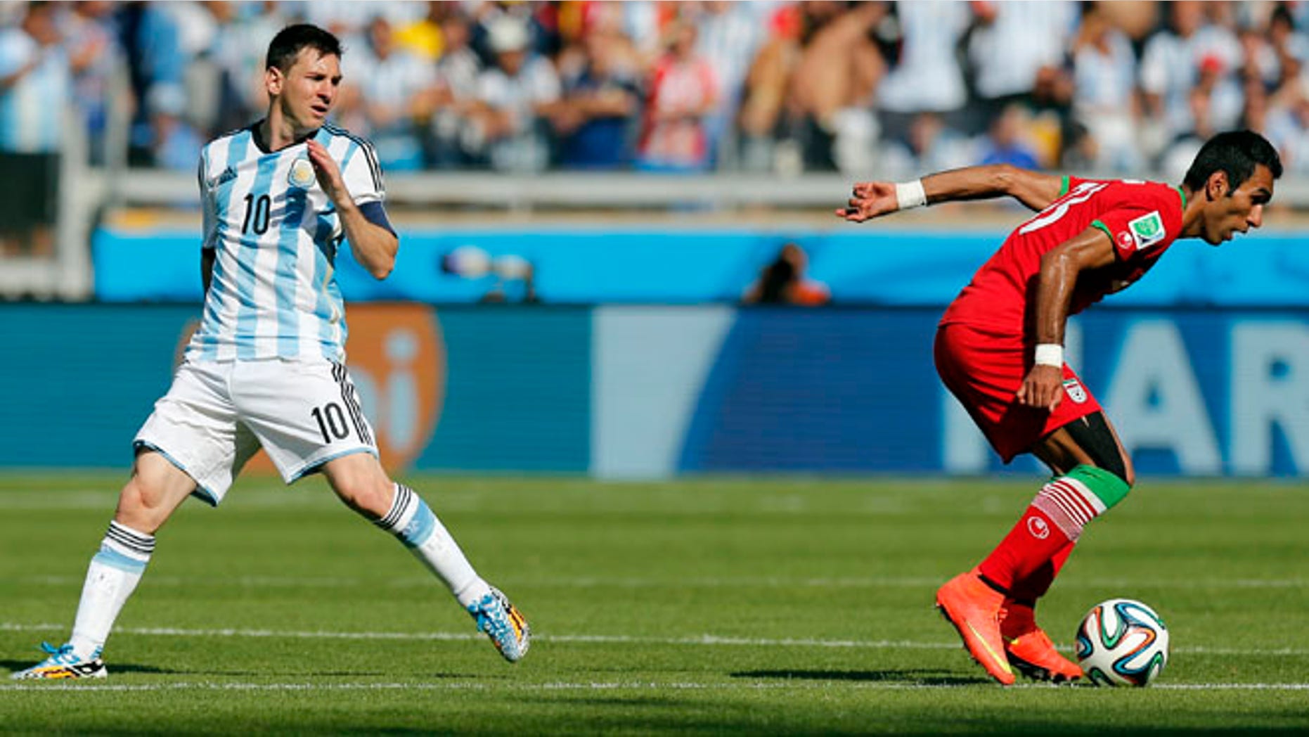 June 21, 2014: Argentina's Lionel Messi, left, watches as Iran's Mehrdad Pooladi takes the ball away from him during the group F World Cup soccer match between Argentina and Iran at the Mineirao Stadium in Belo Horizonte, Brazil.