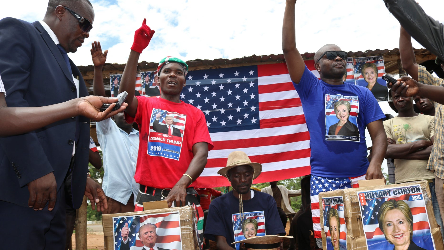 Comedians stage a mock election in the village of Kogelo, the home town of Sarah Obama, step-grandmother of President Barack Obama, in western Kenya, Tuesday, Nov. 8, 2016. Residents of the town made famous by its association with President Obama cast their "votes" for either Hillary Clinton or Donald Trump, with Clinton winning according to an organizer. (AP Photo)