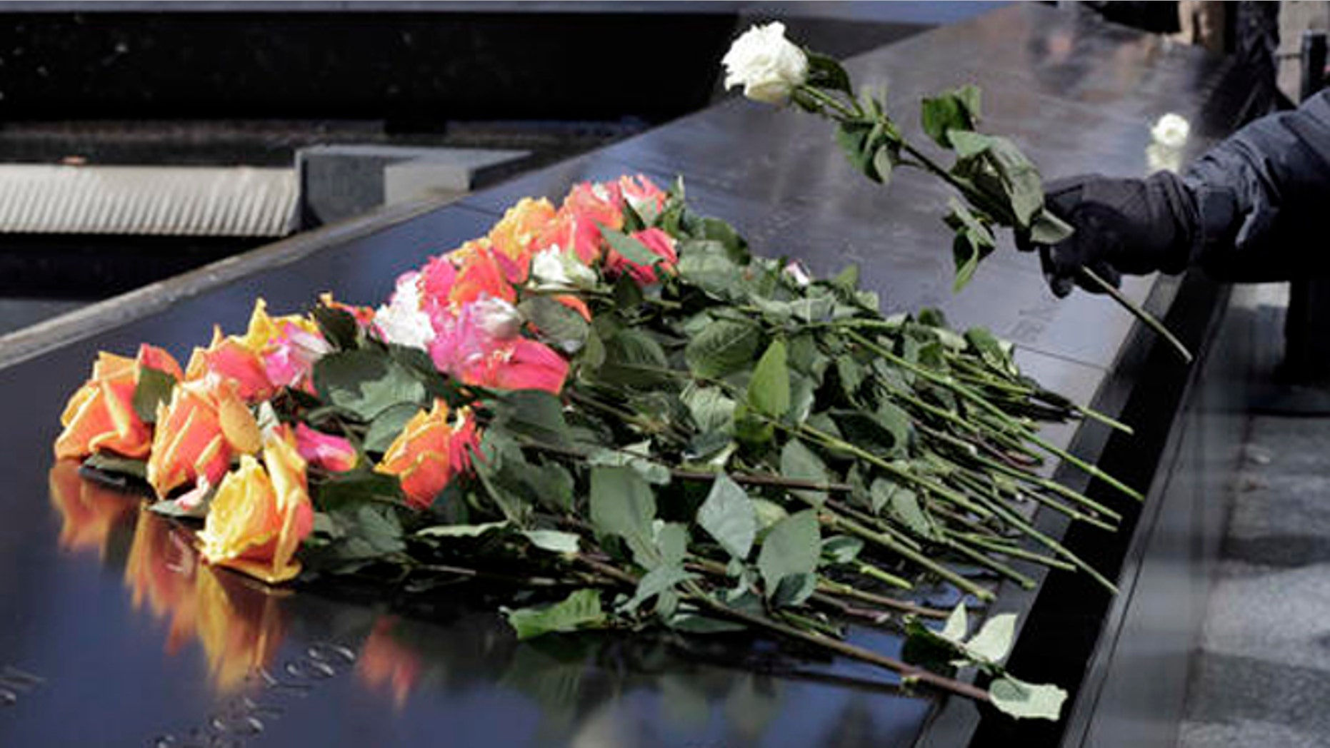 A rose is placed on the 9/11 Memorial during a ceremony commemorating the 23rd anniversary of the 1993 World Trade Center bombing that killed six people and injured more than 1,000, in New York, Friday, Feb. 26, 2016. (AP Photo/Richard Drew)
