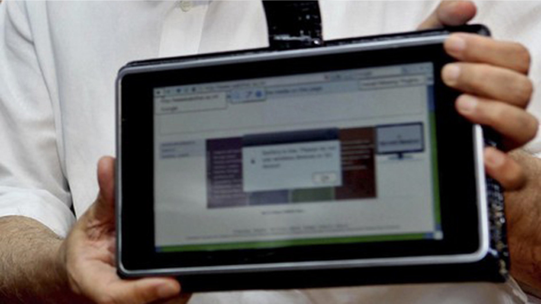 India's Human Resource Development Minister Kapil Sibal displays the low-cost computing device during its unveiling in New Delhi July 22, 2010. India has come up with the world's cheapest "laptop," a touch-screen computing device that costs $35. Human Resource Development Minister Kapil Sibal this week unveiled the low-cost computing device that is designed for students, saying his department had started talks with global manufacturers to start mass production. Picture taken July 22, 2010.