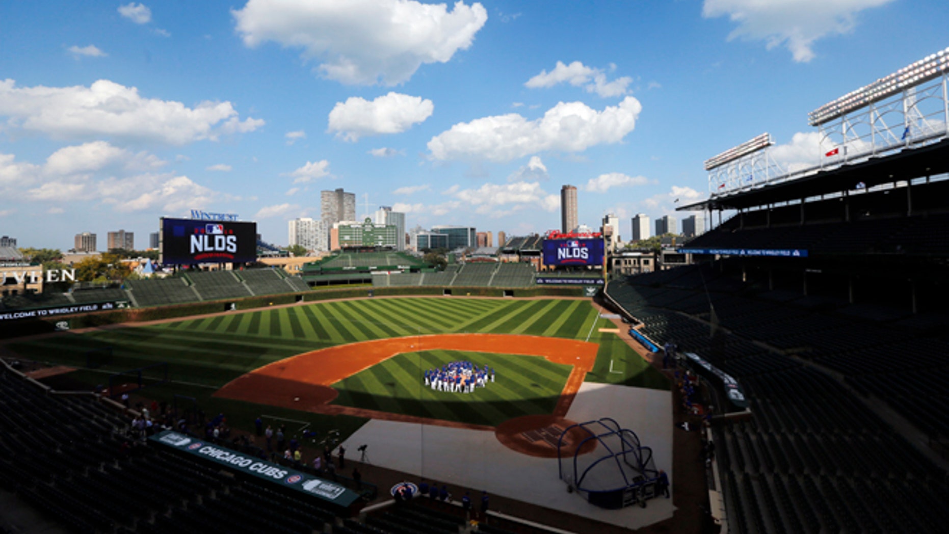 FILE - In this Oct. 5, 2016 file photo, Chicago Cubs players gather around manager manager Joe Maddon on the mound at Wrigley Field as they prepare for Game 1 of the National League Division Series baseball game, in Chicago.
