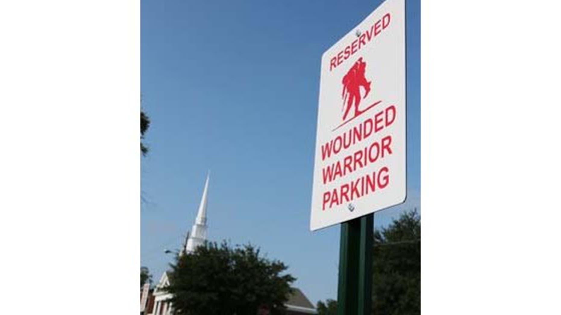 The Daily News of Jacksonville reports that the wounded red-and-white warrior parking signs will feature a logo of a soldier carrying a wounded fellow soldier from the battlefield. (John Althouse/The Daily News)