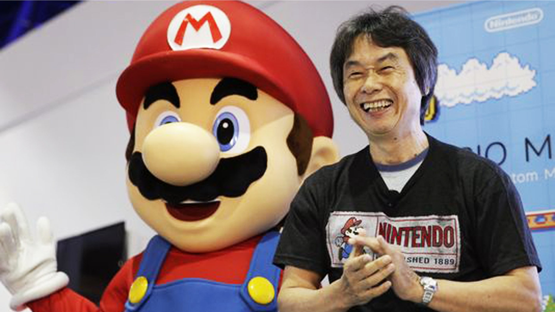 Shigeru Miyamoto, the creator of "Mario Bros." and "Donkey Kong," poses with a Super Mario character at a 2014 promotional event.
