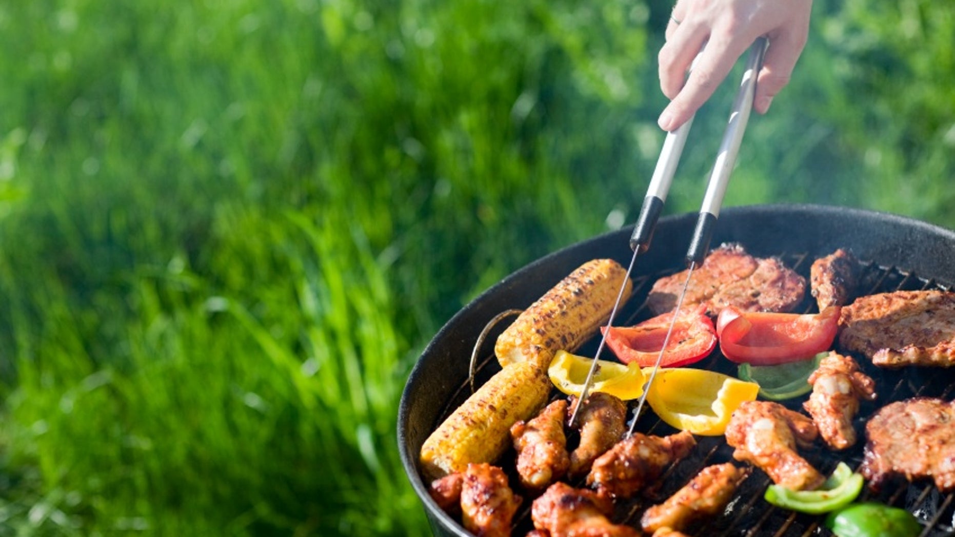 Grilling at summer weekend. Fresh meat and vegetables preparing on grill.
