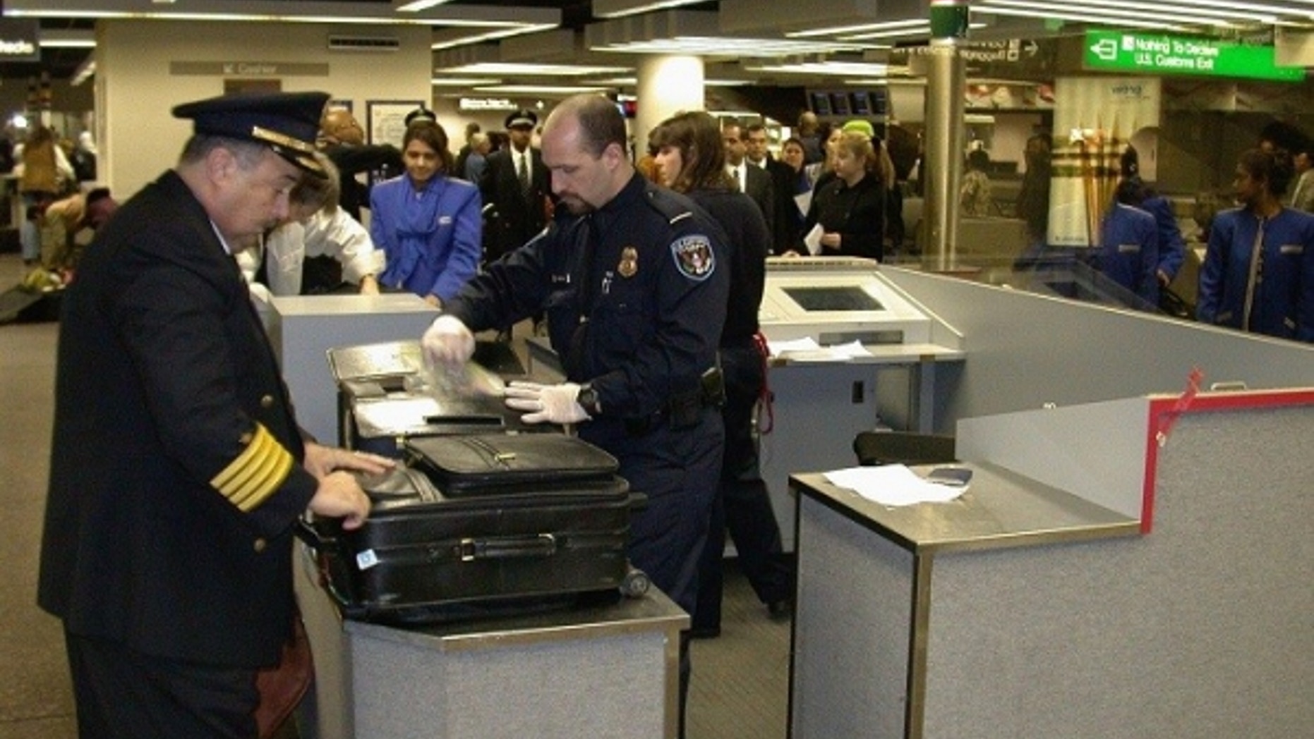Customs agents inspect airline passenger bags at New York's John F. Kennedy Airport.