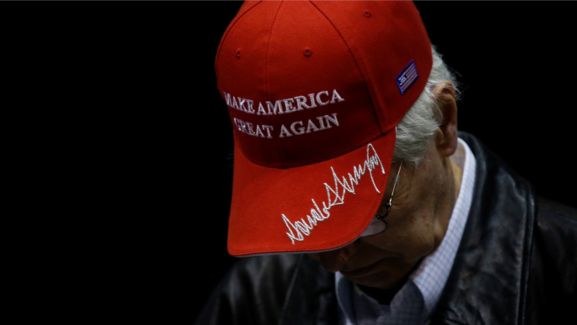 FILE:A man wears a hat embroidered with U.S. President Trump's signature at a Trump rally Nashville.