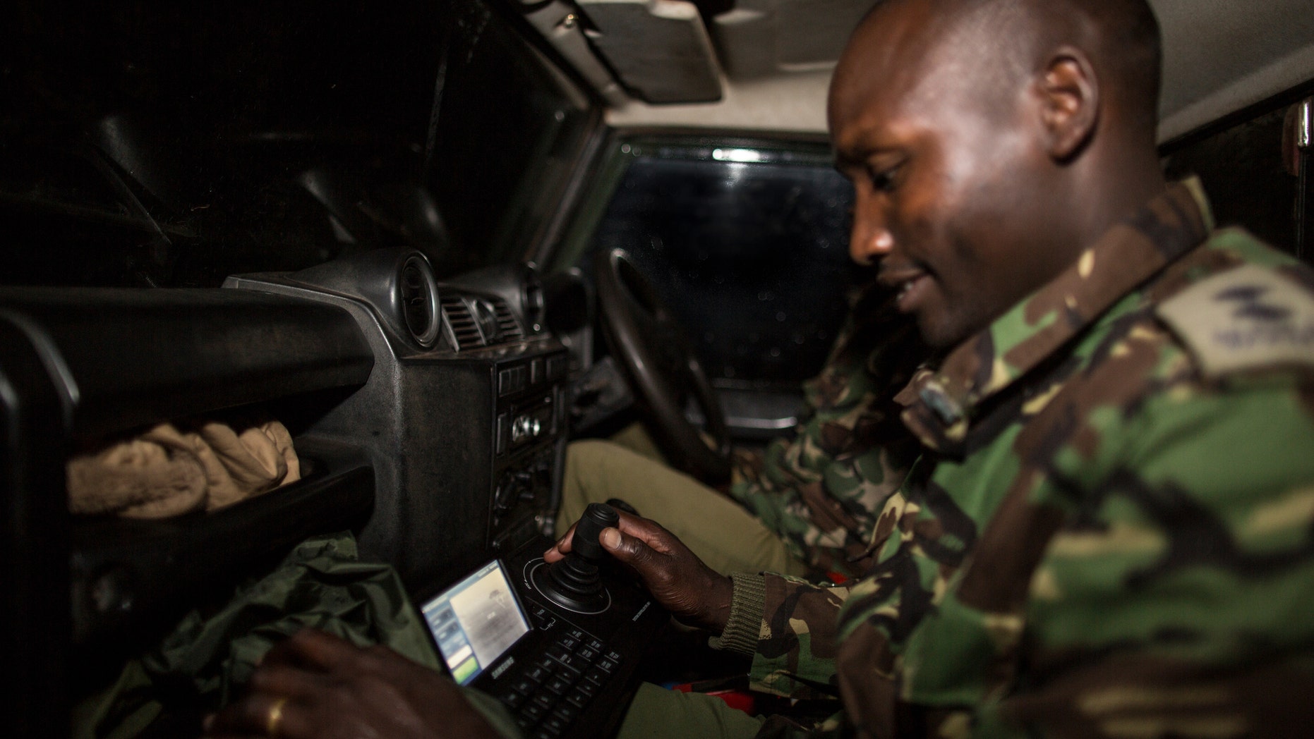 A ranger testing the new mobile FLIR camera unit at the Mara Conservancy at Maasai Mara National Reserve Kenya as part of WWF's Wildlife Crime Technology project (World Wildlife Fund).