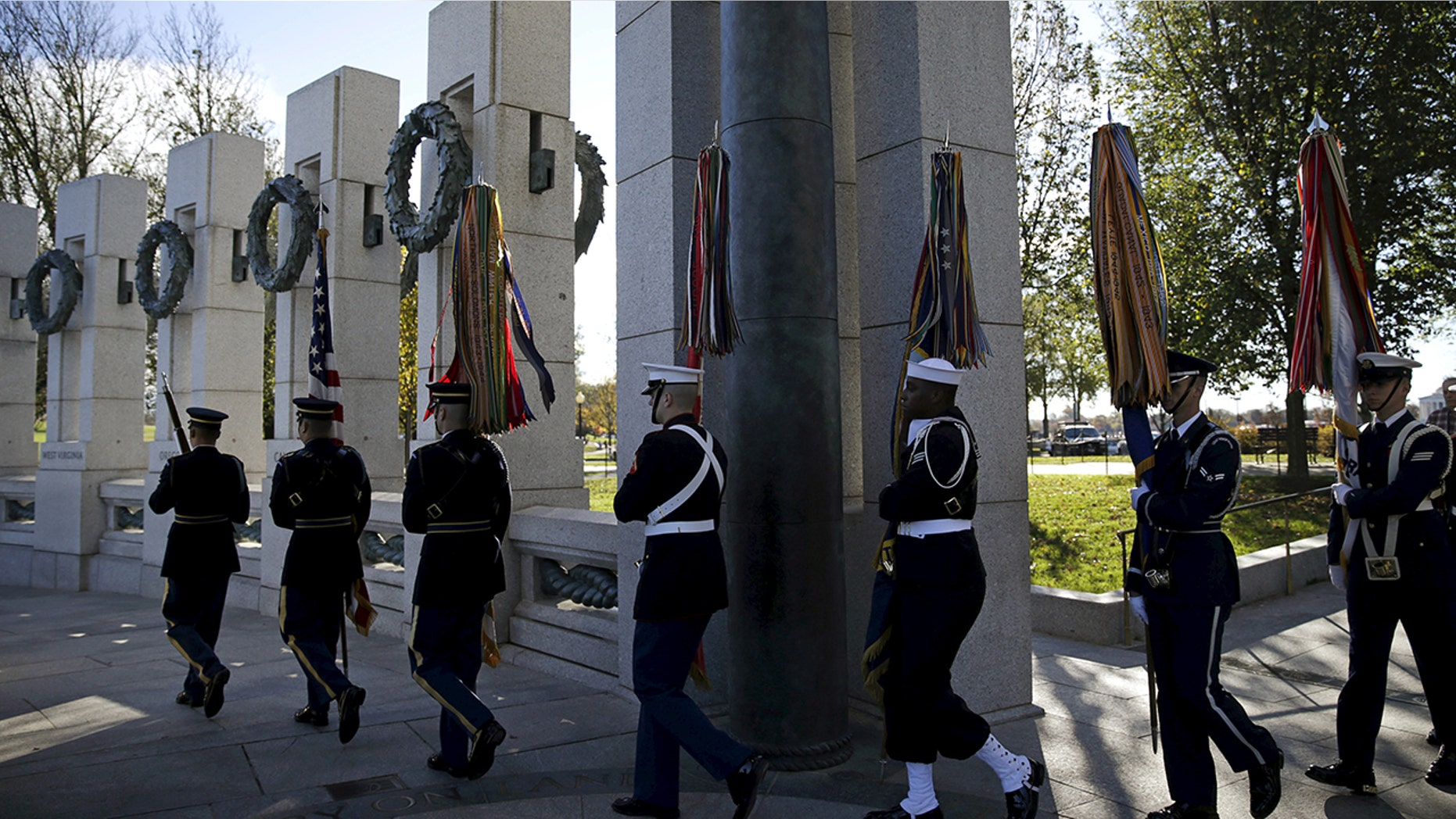 A U.S. military honor guard carries in the colors at the National World War II Memorial in Washington on Veteran's Day to pay tribute to the more than 16 million men and women who served with U.S. armed forces during World War II, Nov. 11, 2015.