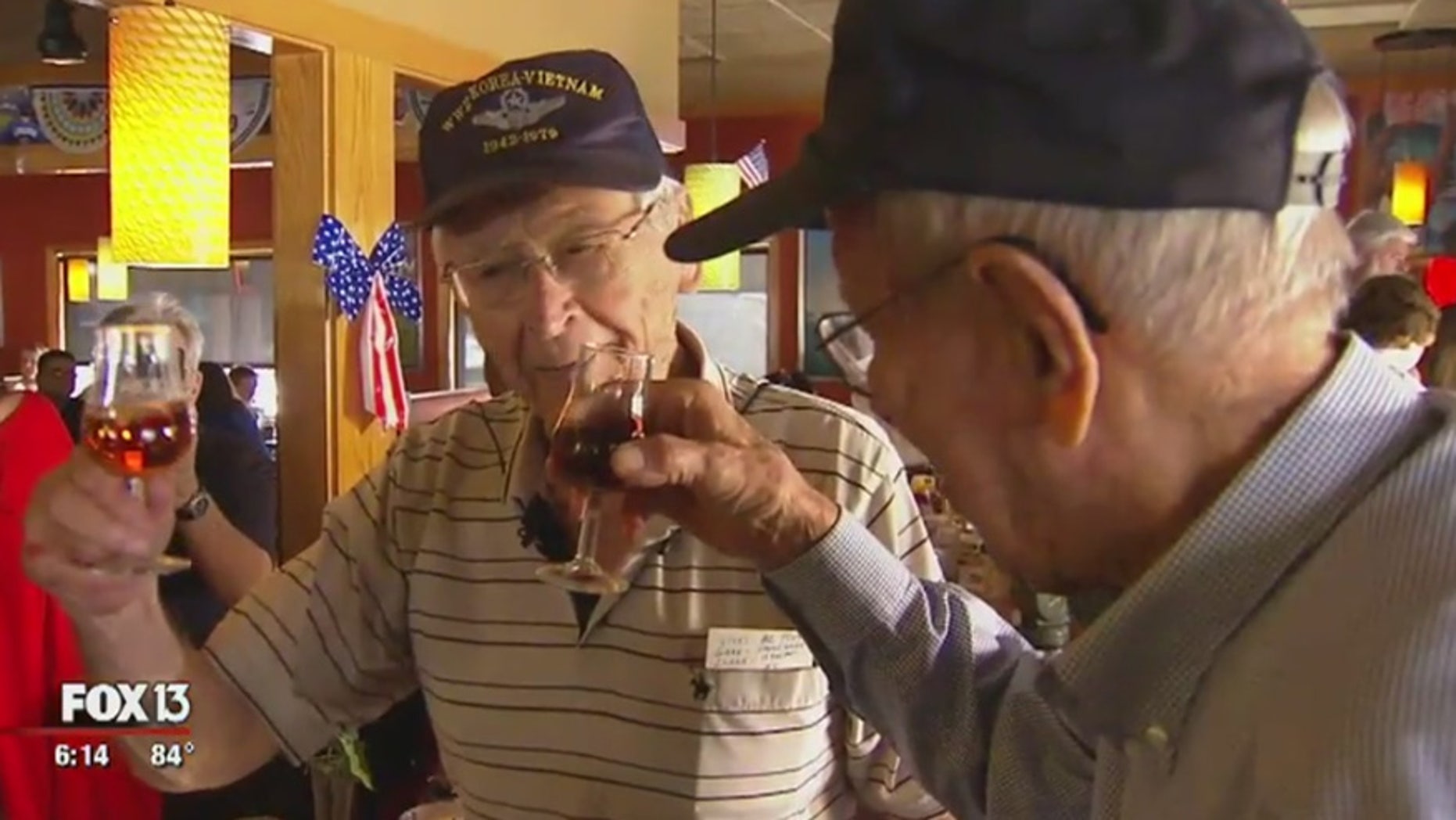 Sanford "Sandy" Graves, left, and Marshall Clark, the last living pilots of the 451st Bomber Squadron, share a toast to their fallen comrades.