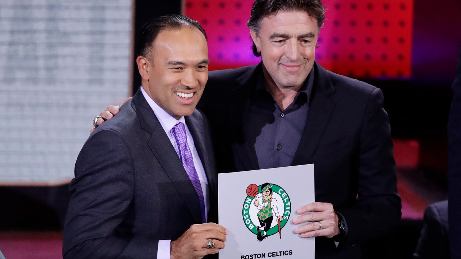 NBA Deputy Commissioner Mark Tatum, left, poses for photographs with Boston Celtics co-owner Wyc Grousbeck, right, after the Celtics won the first pick in the NBA basketball draft, at the draft lottery Tuesday, May 16, 2017, in New York. (AP Photo/Frank Franklin II)