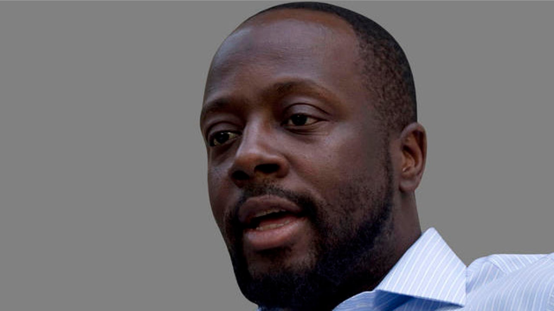Haiti's presidential candidate and hip hop singer Wyclef Jean, center, speaks during an interview with The Associated Press in Croix de Bouquets, Haiti, Wednesday, Aug. 18, 2010. Jean says he has received death threats, which is why he is in seclusion until the electoral list is released. (AP Photo/Ramon Espinosa)