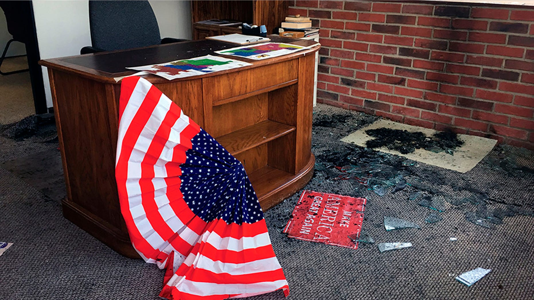 Broken glass and fire damage is shown inside the Albany County Republican Party office following a fire, Thursday, Sept. 6, 2018, in Laramie, Wyo. Authorities say the fire caused minor damage and no injuries and that it is being investigated as arson. (Shannon Broderick/Laramie Boomerang via AP)