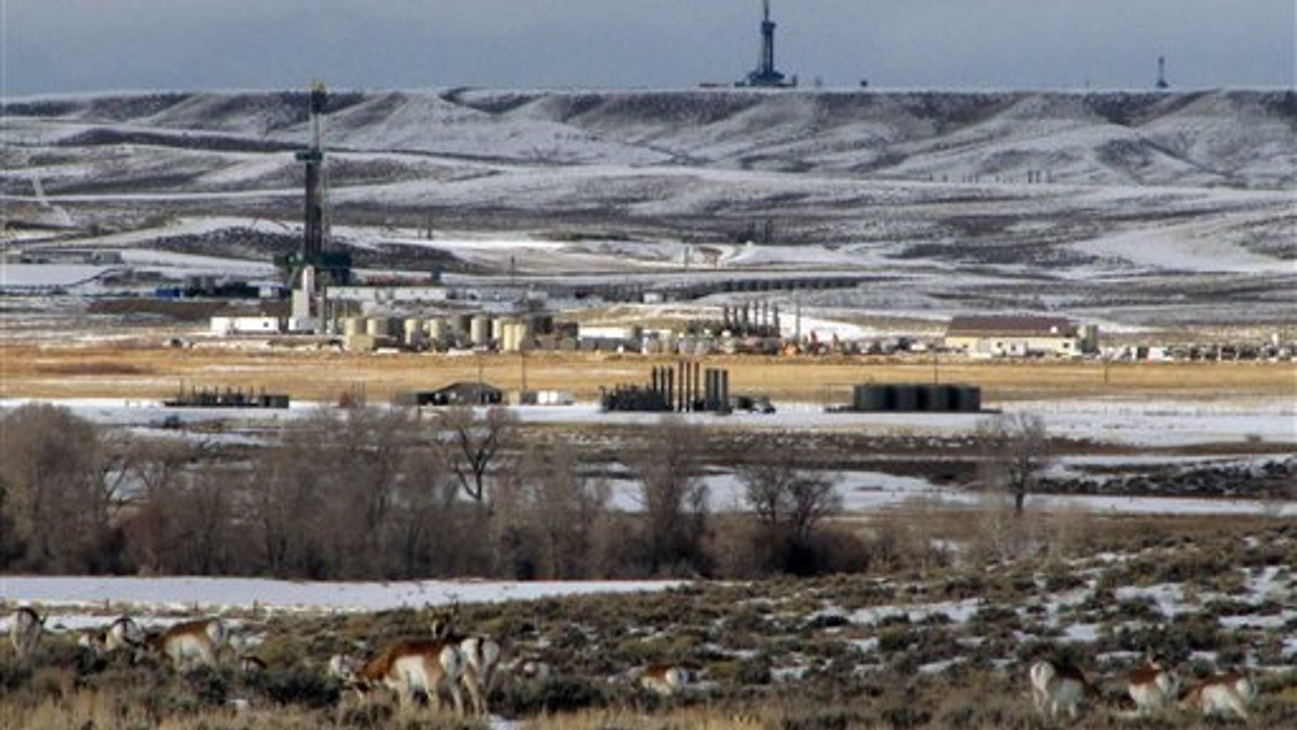In this Jan. 22, 2010 photo, antelope graze not far from gas drilling rigs in western Wyoming's Upper Green River Basin, where ozone levels last week exceeded the worst days in major U.S. cities last year. (AP Photo/Mead Gruver)