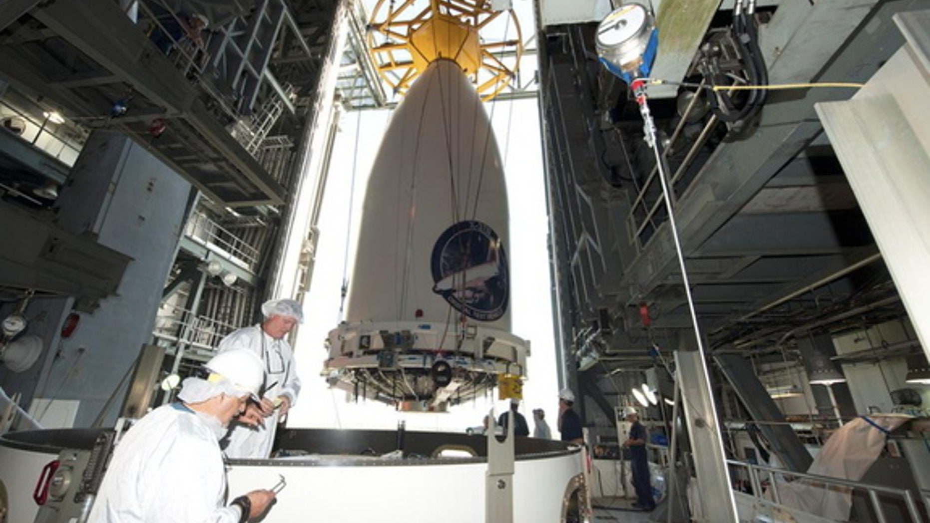 The Air Force's robotic X-37B space plane, encapsulated in its fairing, being readied for attachment to its Atlas V rocket ahead of a planned May 20, 2015 launch.
