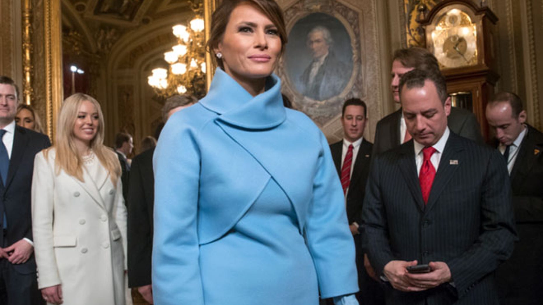 Melania Trump wore a sky-blue cashmere jacket and mock turtleneck dress by Ralph Lauren
